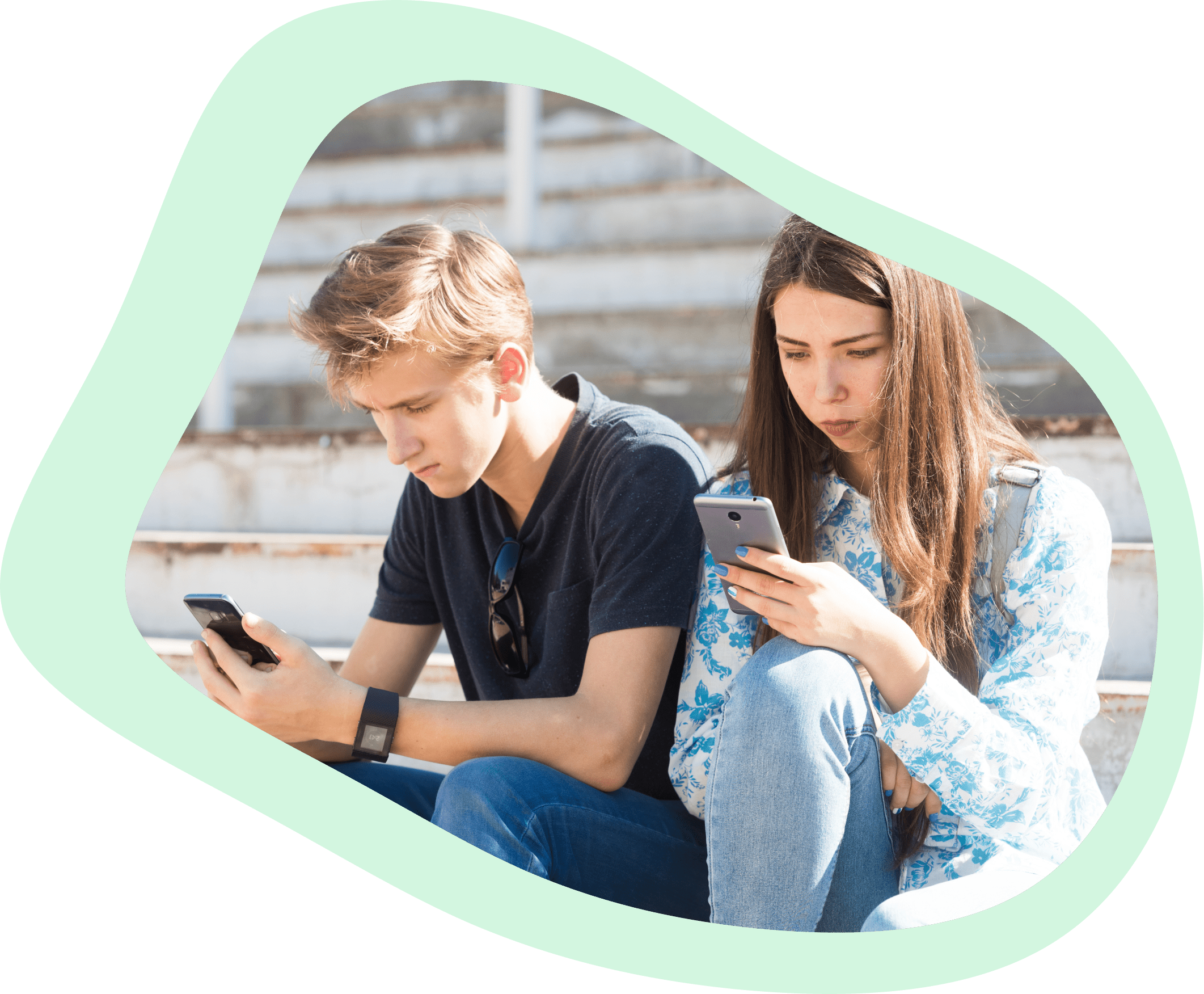 A teenage boy and girl looking at their mobile device with custom alerts