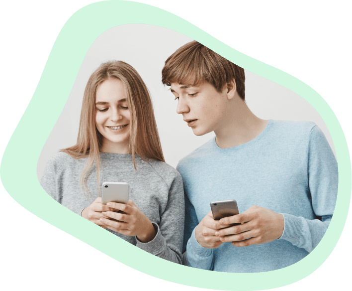 Two teenagers with their mobile, depicting non-intrusive monitoring